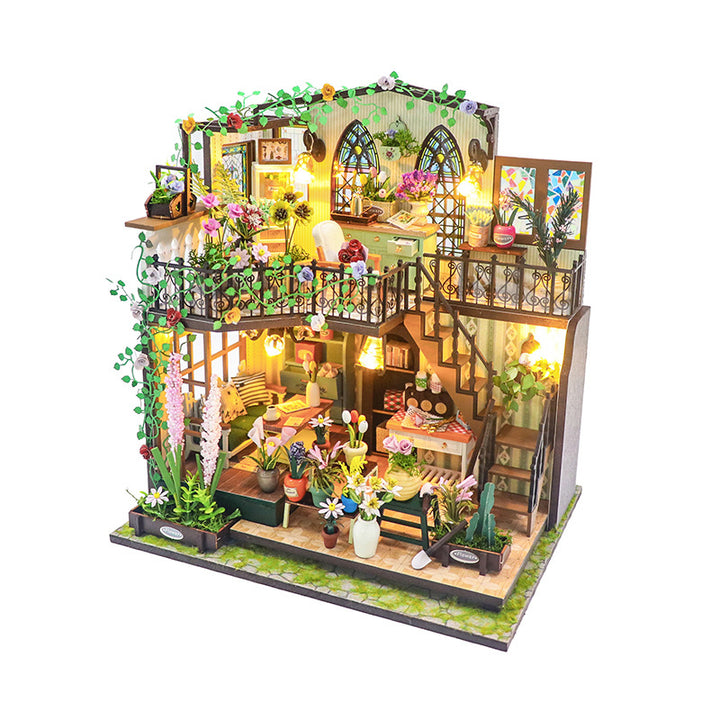 Daisy's Flower Room DIY dollhouse kit showcasing detailed miniature design with plants and lighting.