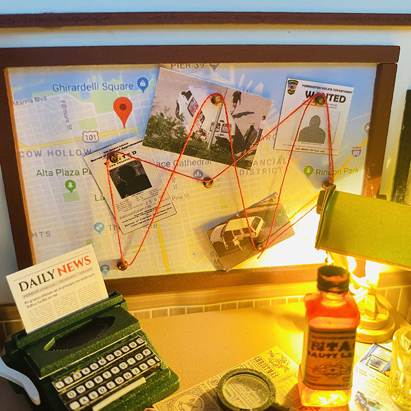 Miniature detective board with photos, maps, and a typewriter in a DIY dollhouse kit setting.