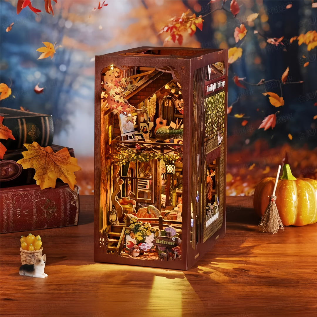 3D wooden puzzle book nook kit featuring Twilight Cottage, decorated with autumn leaves and cozy cottage interiors.
