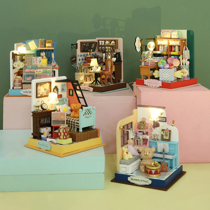 Colorful DIY dollhouse kits with lights, featuring mini rooms and detailed decor, perfect for creative assembly activities.