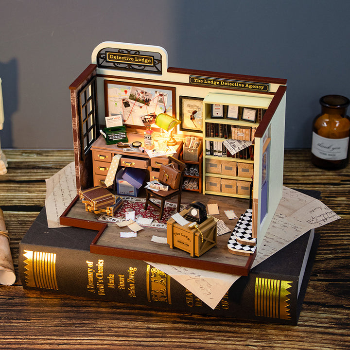 DIY Dollhouse Kit of a detective agency interior, featuring a desk, shelves, and mini decor, perfect for craft lovers.