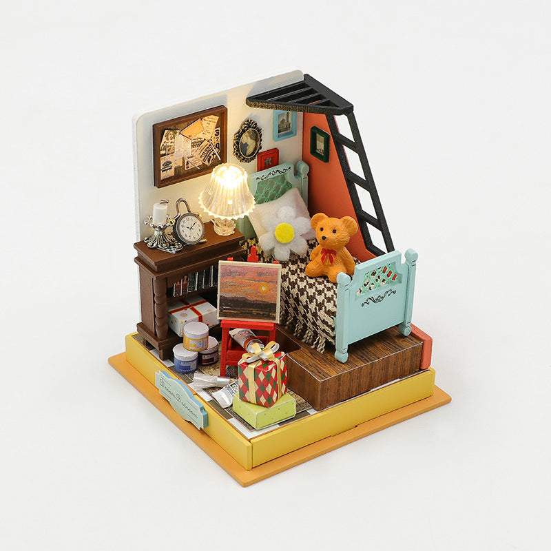 Mini DIY dollhouse with cozy room scene, featuring a teddy bear, furniture, and decorative elements.