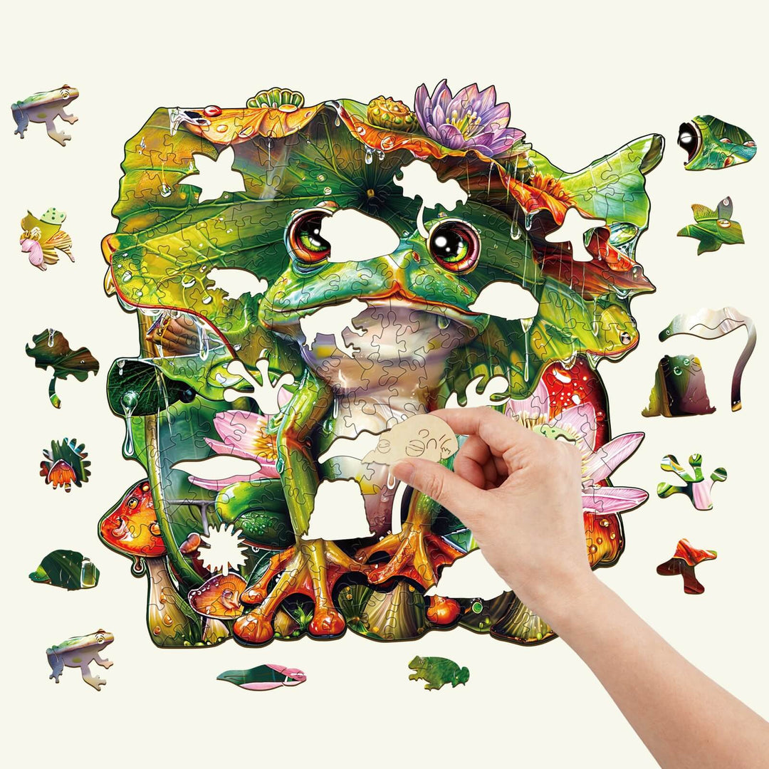 Colorful Frog Wooden Jigsaw Puzzle with a hand placing a piece, ideal for improving focus and cognitive skills.