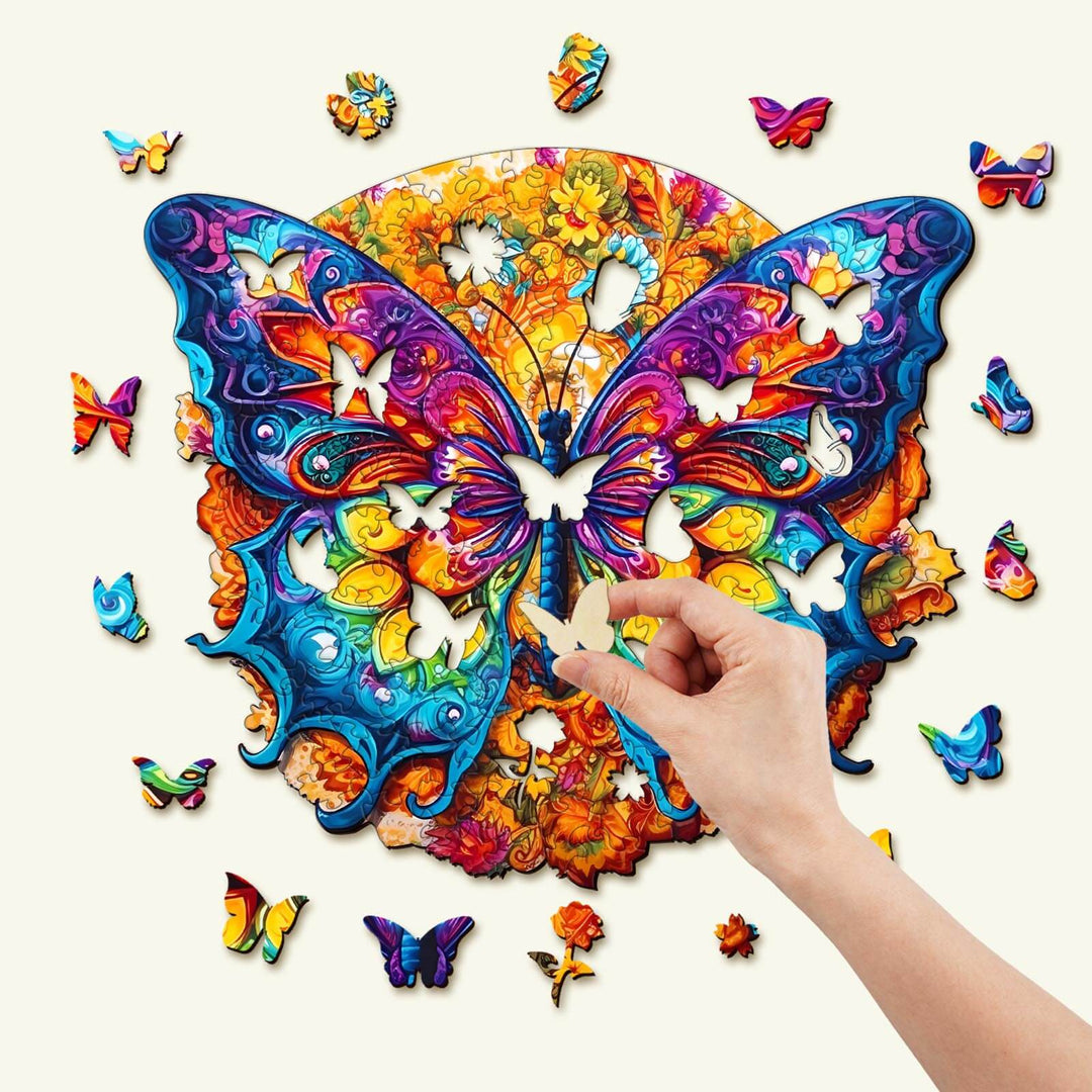 Hand assembling a colorful Mandala Butterfly wooden jigsaw puzzle with unique animal-shaped pieces.