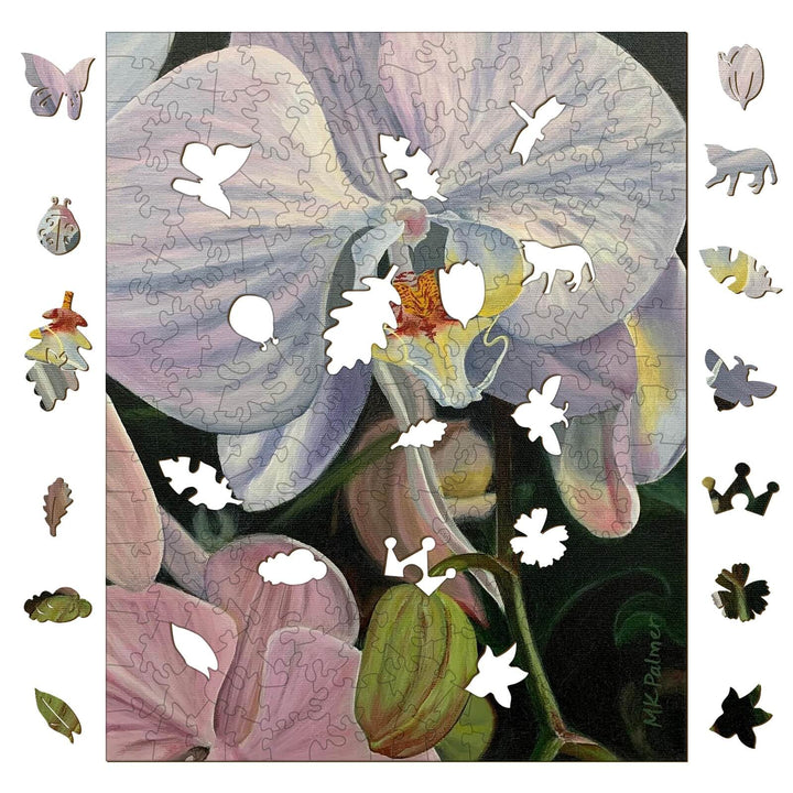 Close-up of an orchid puzzle by artist Marianne K Palmer, featuring missing puzzle pieces and floral designs.