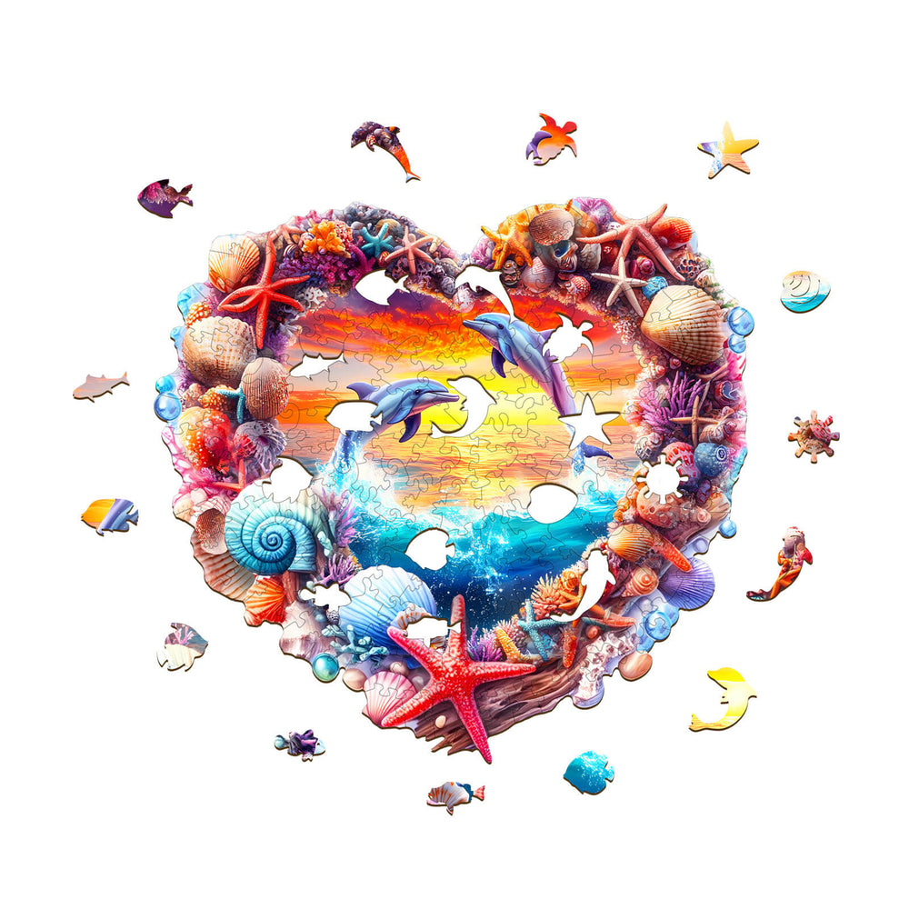 Colorful coral and dolphin wooden jigsaw puzzle in heart shape, featuring sea life and a sunset background.