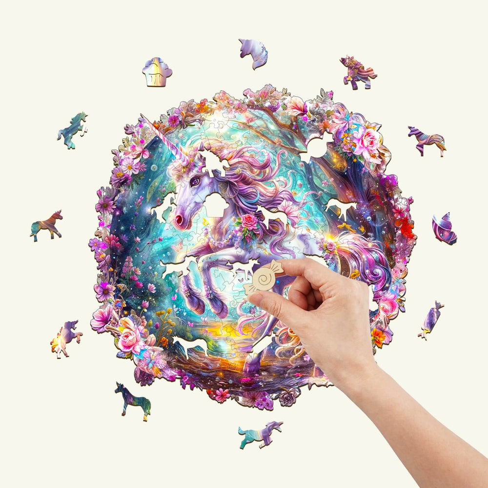 A hand fitting a piece into a colorful Elf Pony jigsaw puzzle featuring a mystical unicorn design.