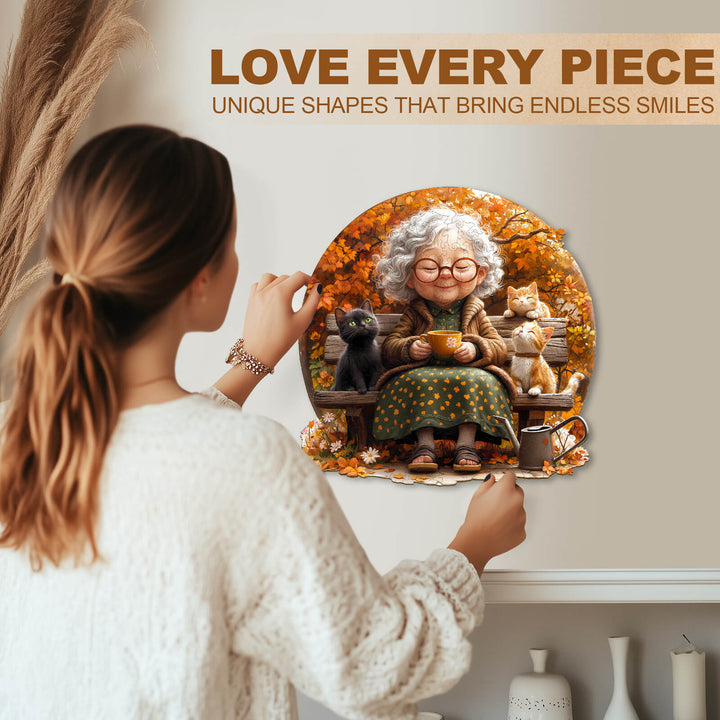 Woman enjoying a jigsaw puzzle featuring a joyful grandmother with pets in autumn foliage, perfect for puzzle enthusiasts.