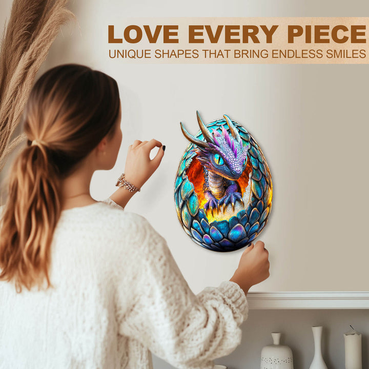 Woman placing a Draconic Rebirth wooden jigsaw puzzle piece with colorful dragon design on a wall, promoting focus and fun.