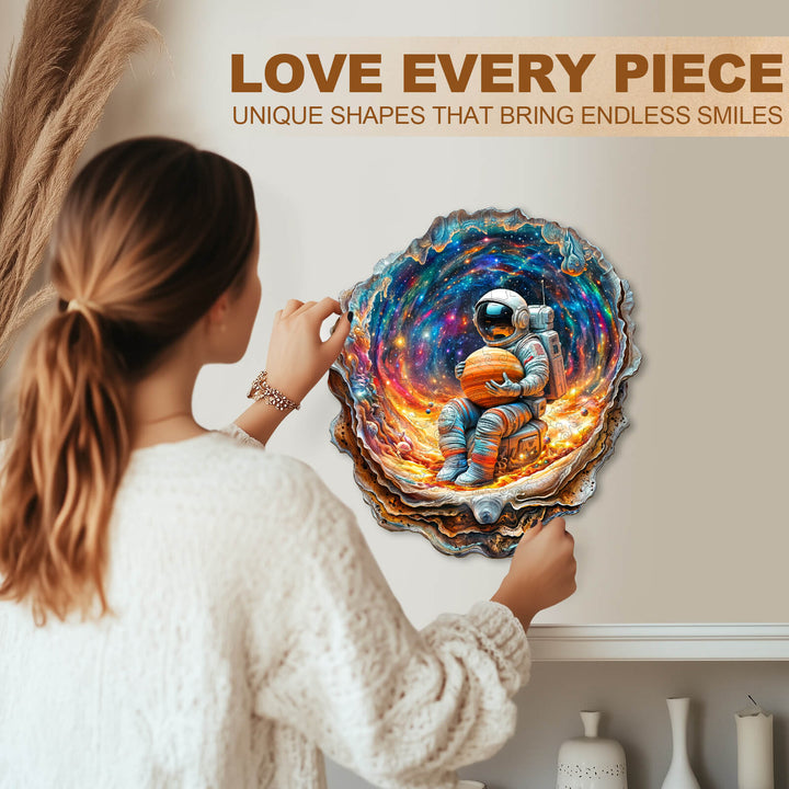 Woman engaging with a Cosmic Dream wooden jigsaw puzzle featuring a colorful astronaut design.