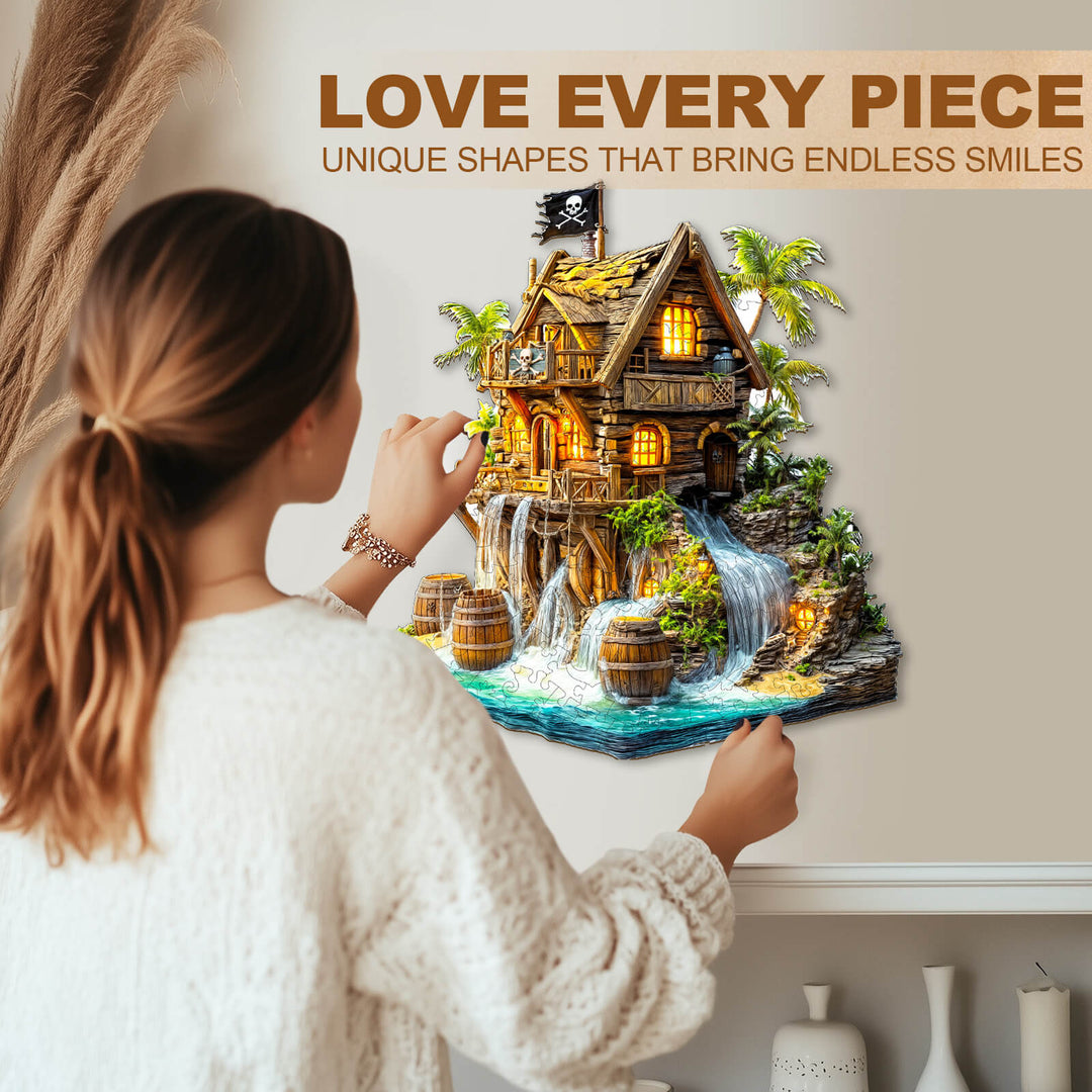 Person assembling a Pirate cabin-2 wooden jigsaw puzzle featuring unique shapes and vibrant colors.