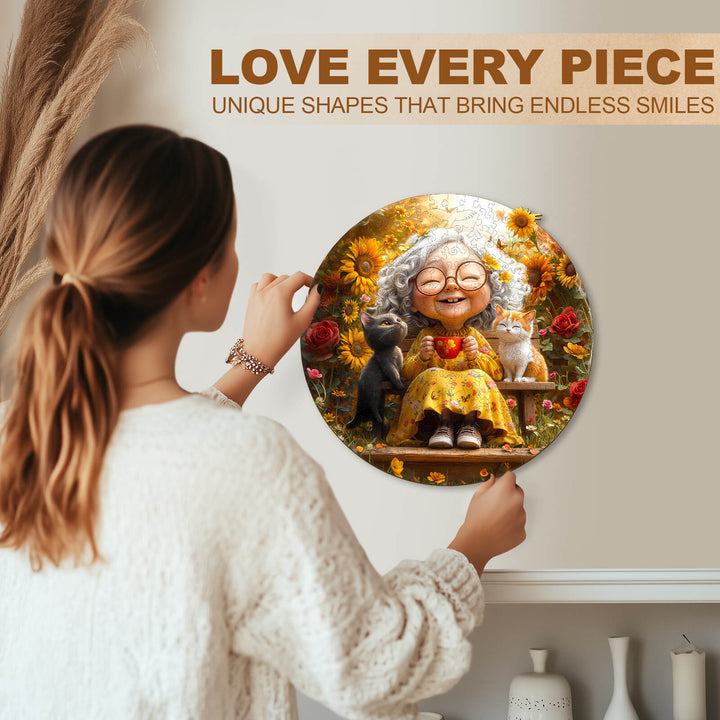 Person assembling a colorful jigsaw puzzle featuring a joyful elderly woman and her pets in a sunflower garden.