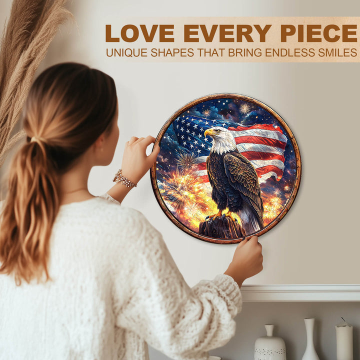 Woman holding the Eagle's Pride Wooden Jigsaw Puzzle featuring an eagle and American flag on a decorative wall.
