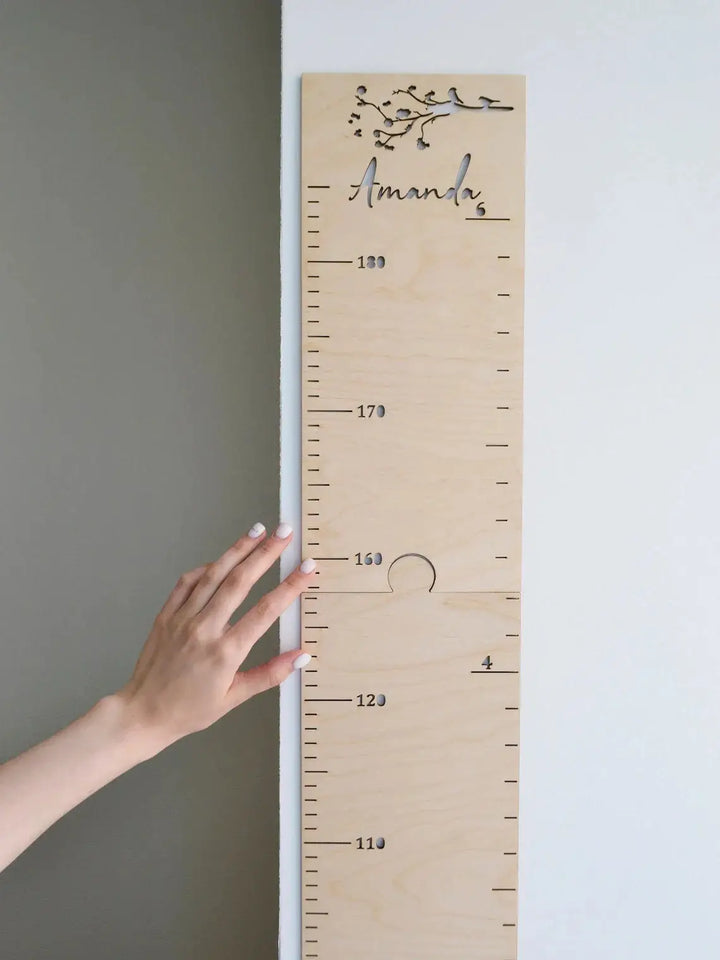 Personalized wooden growth chart ruler with animal patterns, measuring child's height, engraved with name Amanda.