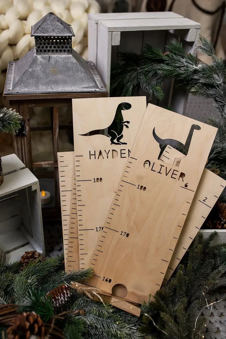 Personalized wooden growth charts with dinosaur designs for kids' rooms, featuring engraved names and measurement scales.