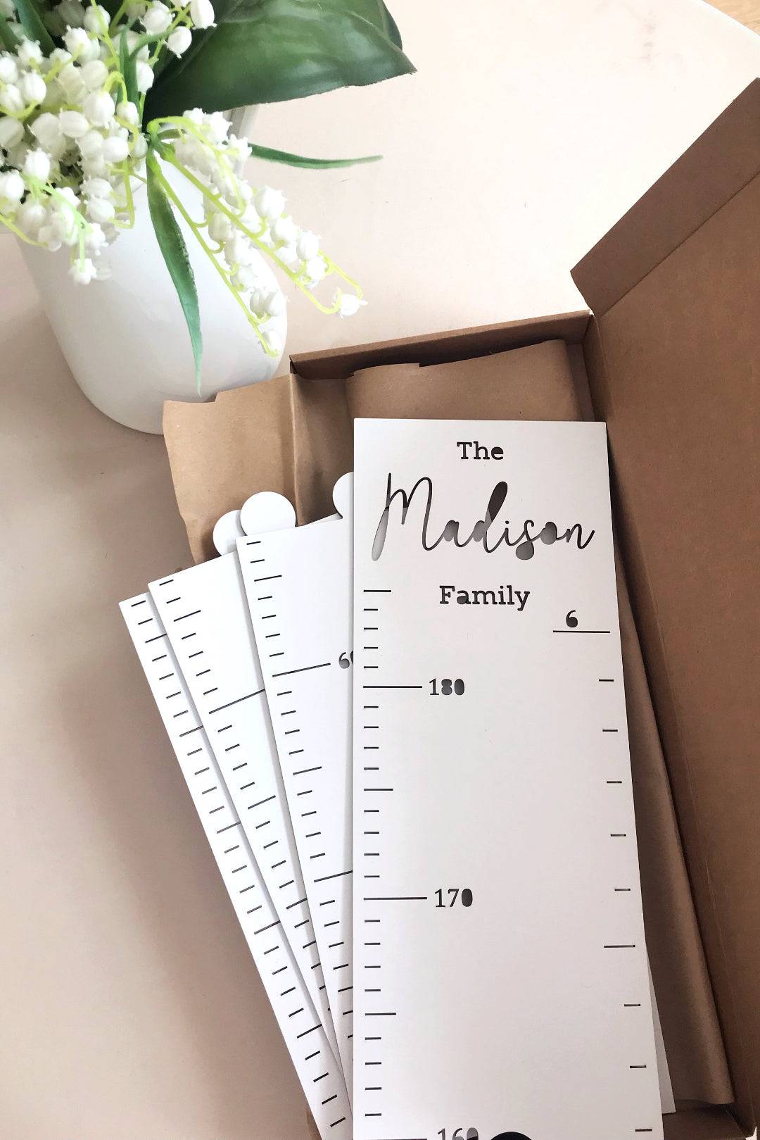 Personalized wooden growth chart for kids, featuring the name 'Madison' surrounded by flower decor.