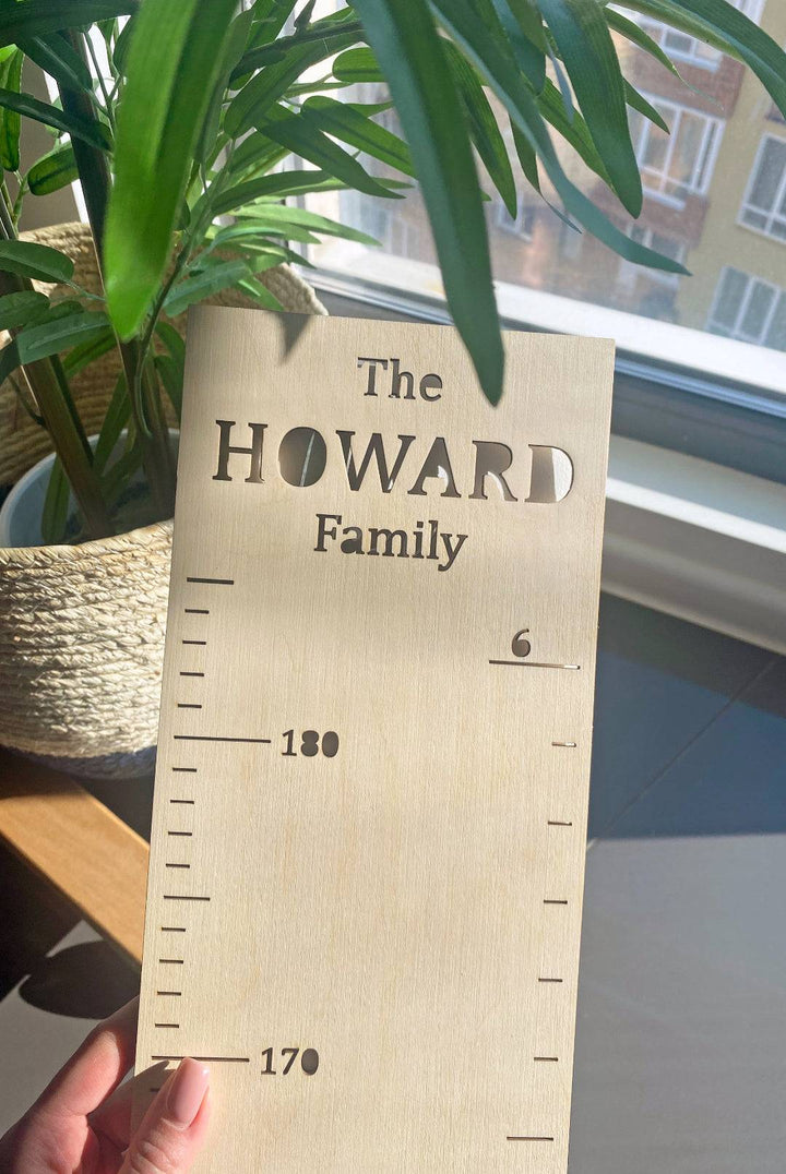 Personalized wooden height ruler for kids with the name 'HOWARD', perfect for tracking children's growth.