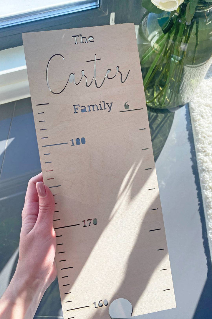 Personalized wooden growth chart for kids, featuring the name 'Carter' and clear measurement scales.