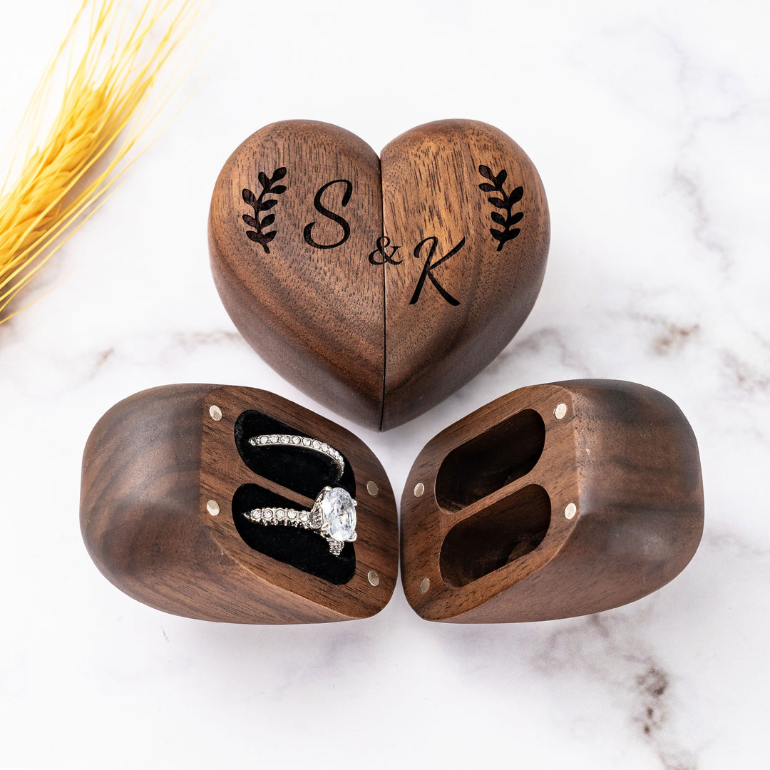 Custom walnut heart-shaped ring box with couple's initials, perfect for engagements or anniversaries.