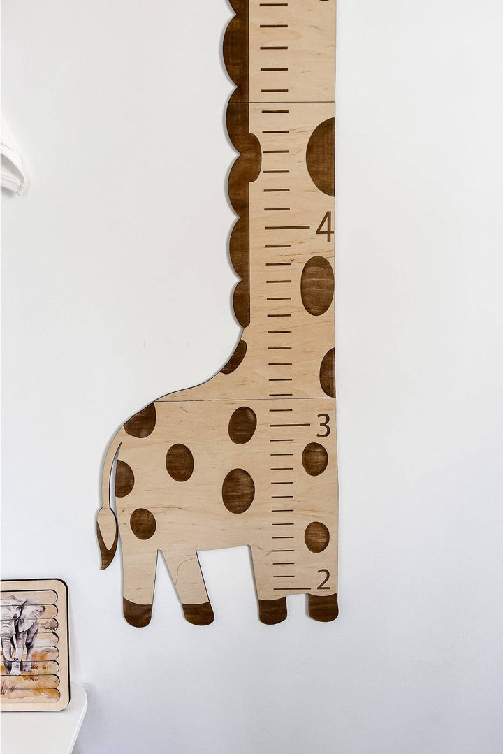 Wooden giraffe growth chart height ruler for kids decor, measuring children's growth with playful design.