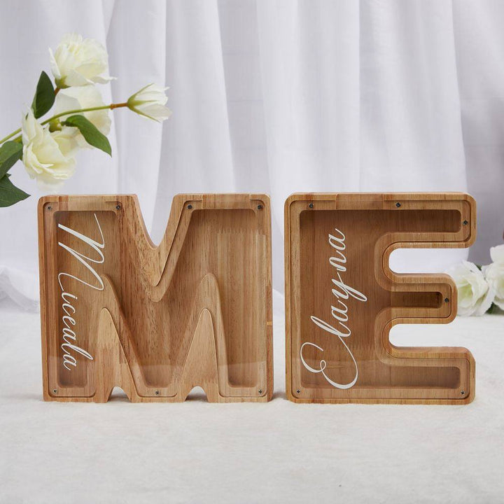 Personalized wooden letters ME piggy bank for kids, teaching savings and financial awareness.