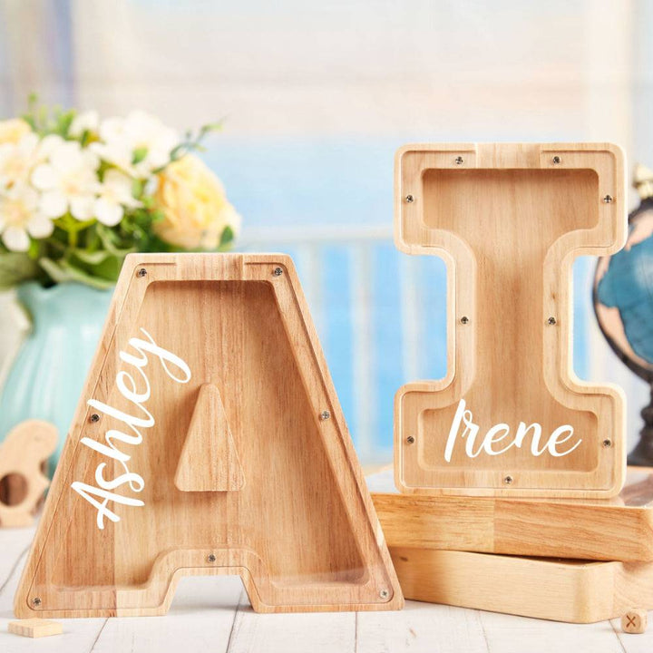 Personalized wooden letter piggy bank for kids featuring letters A and I with names Ashley and Irene.
