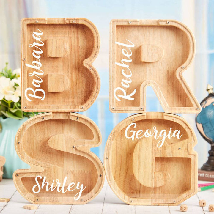 Personalized wooden letter piggy banks featuring names for kids' financial education.