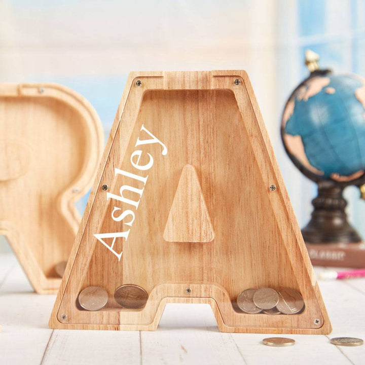 Personalized wooden letter piggy bank 'A' for kids, designed for savings and financial awareness.