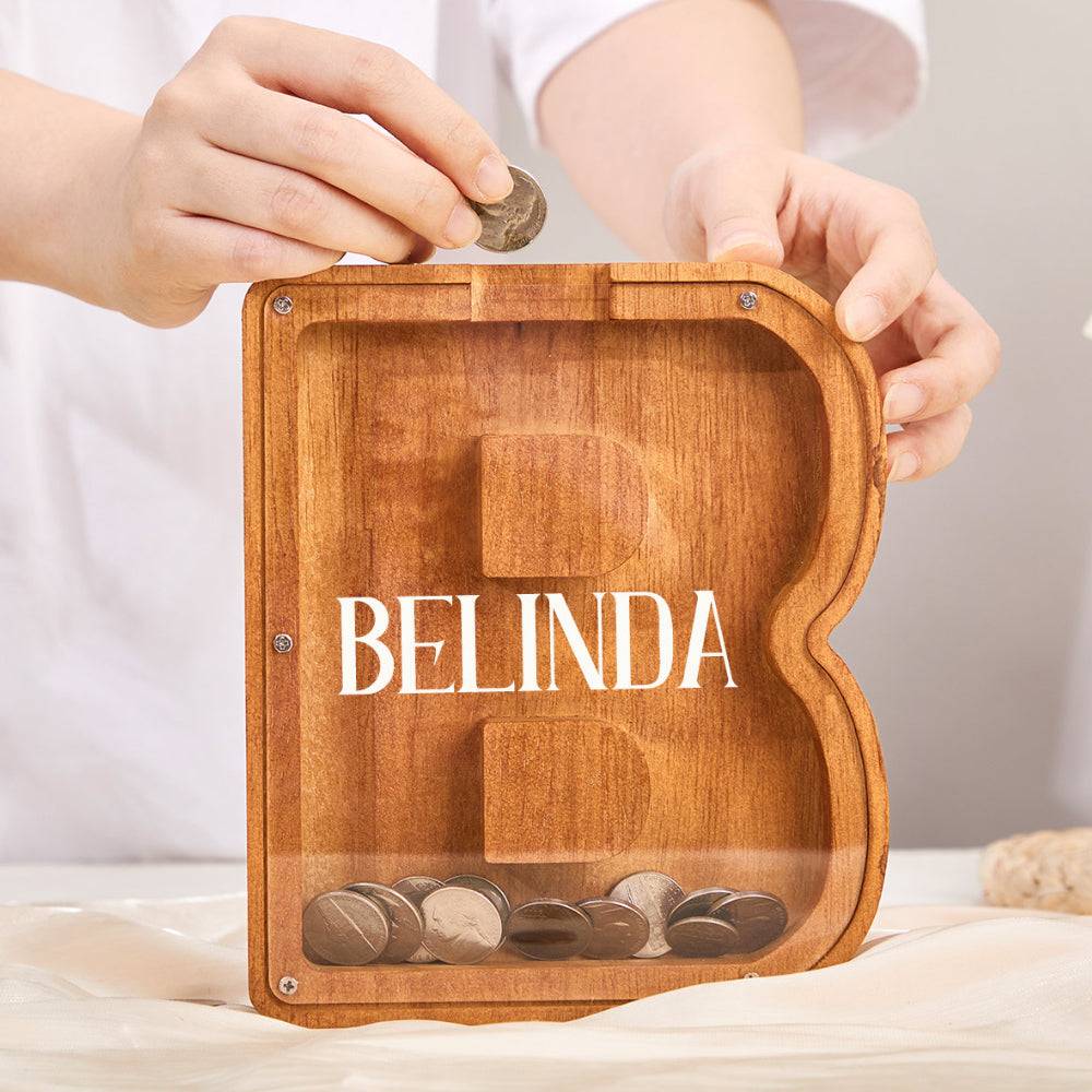 Custom wooden letter piggy bank with coins, personalized for children, promoting savings and financial awareness.