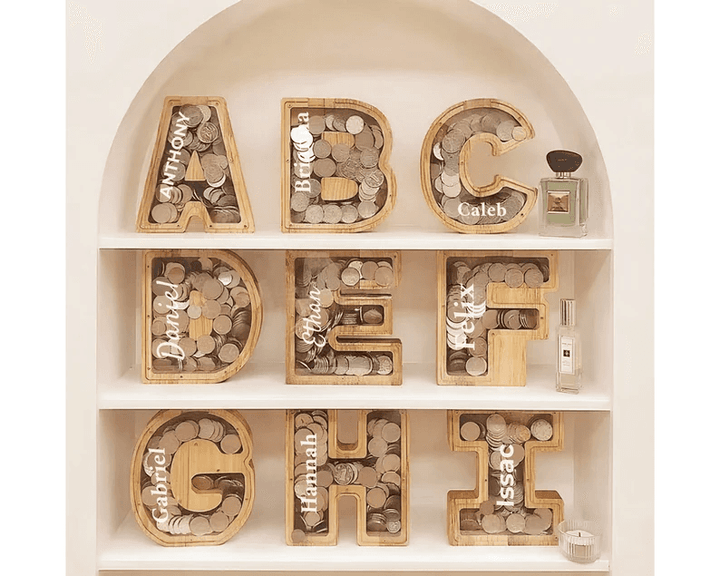 Personalized wooden letter piggy banks filled with coins, promoting savings and financial awareness for kids.