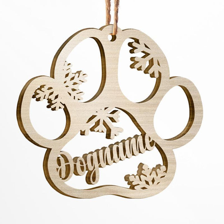 Personalized wooden dog paw ornament with snowflakes, perfect for Christmas decorations or pet memorials.