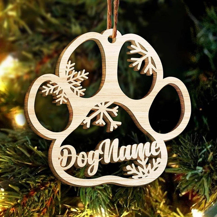 Personalized wooden dog paw ornament with snowflakes, perfect for Christmas decorations.