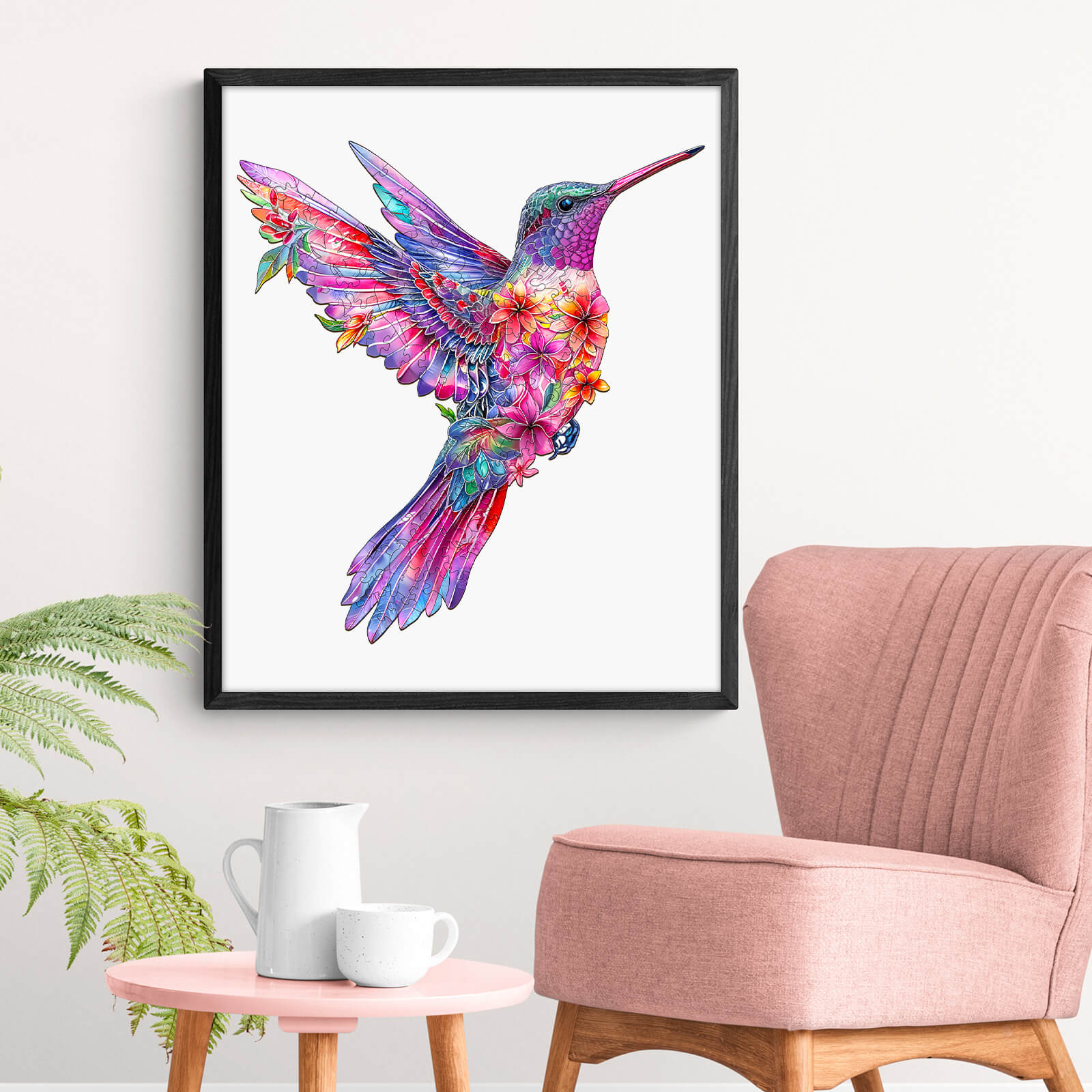 Colorful hummingbird artwork displayed in a modern living space with stylish chair and decor.