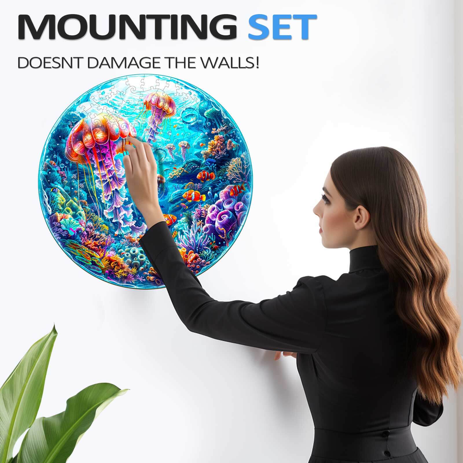 A woman mounting a colorful spherical ocean jigsaw puzzle on a wall without damaging it, showcasing its vibrant design.