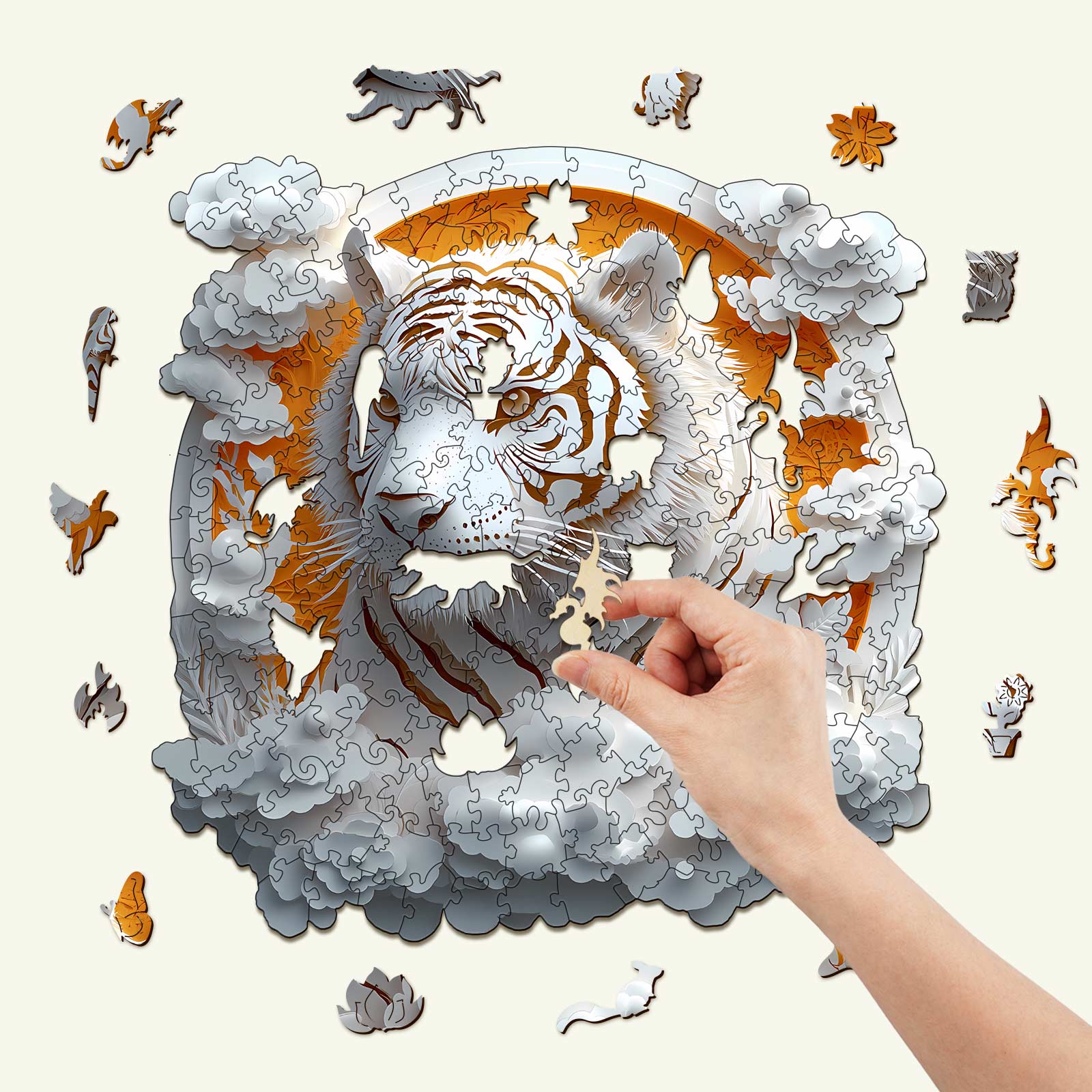 Hand assembling a 3D Paper Tiger wooden jigsaw puzzle surrounded by colorful puzzle pieces.