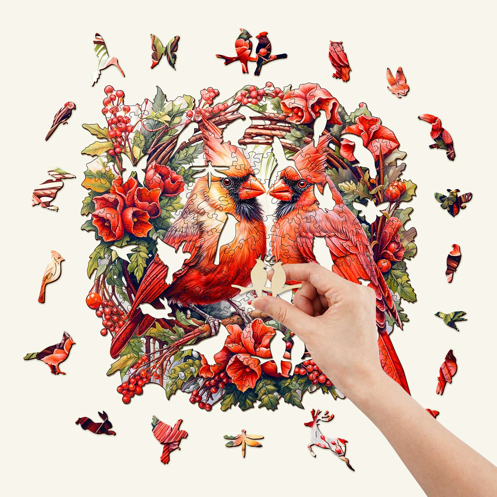 Hand placing a piece in a colorful Cardinal wooden jigsaw puzzle with vibrant flowers and birds.