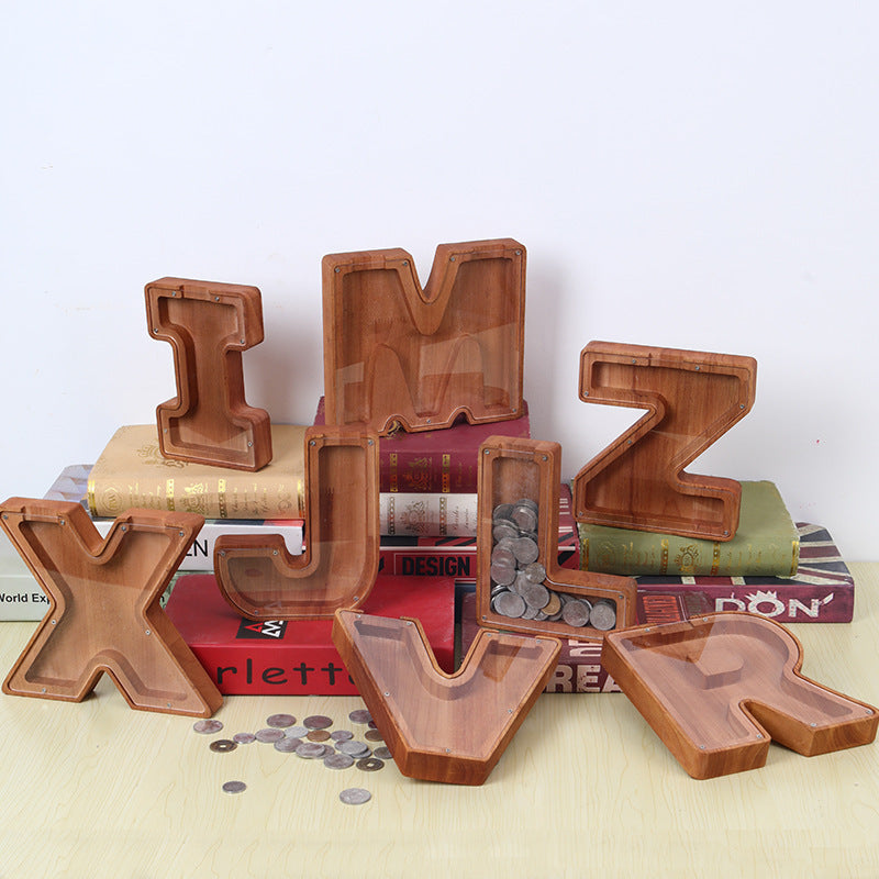 Personalized wooden letter piggy banks in various letters, ideal custom gift for kids, perfect for birthday celebrations.