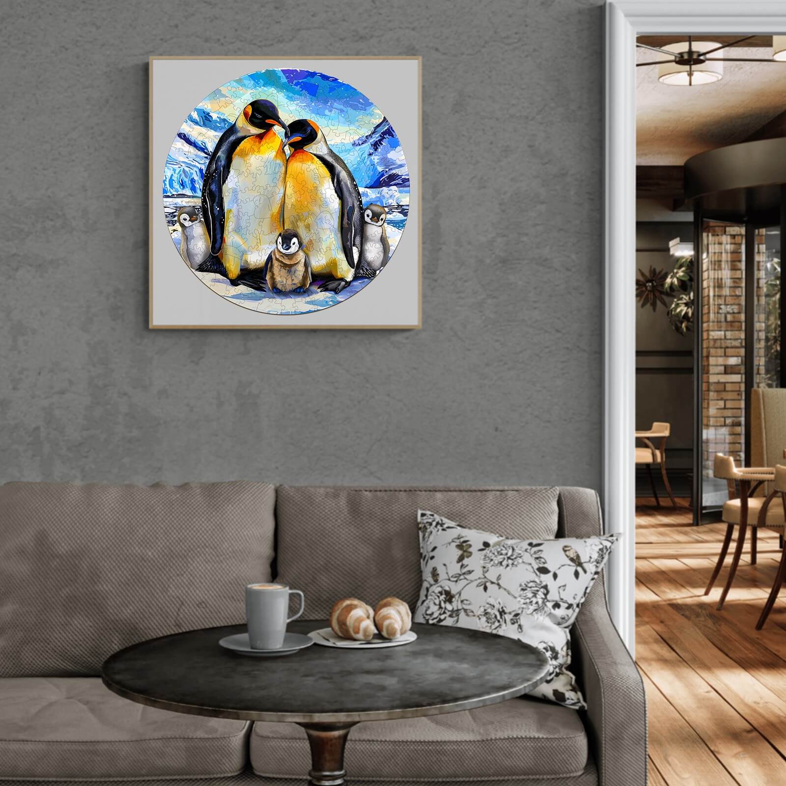 Penguin family artwork in a modern living room setting with cozy decor and a coffee table.