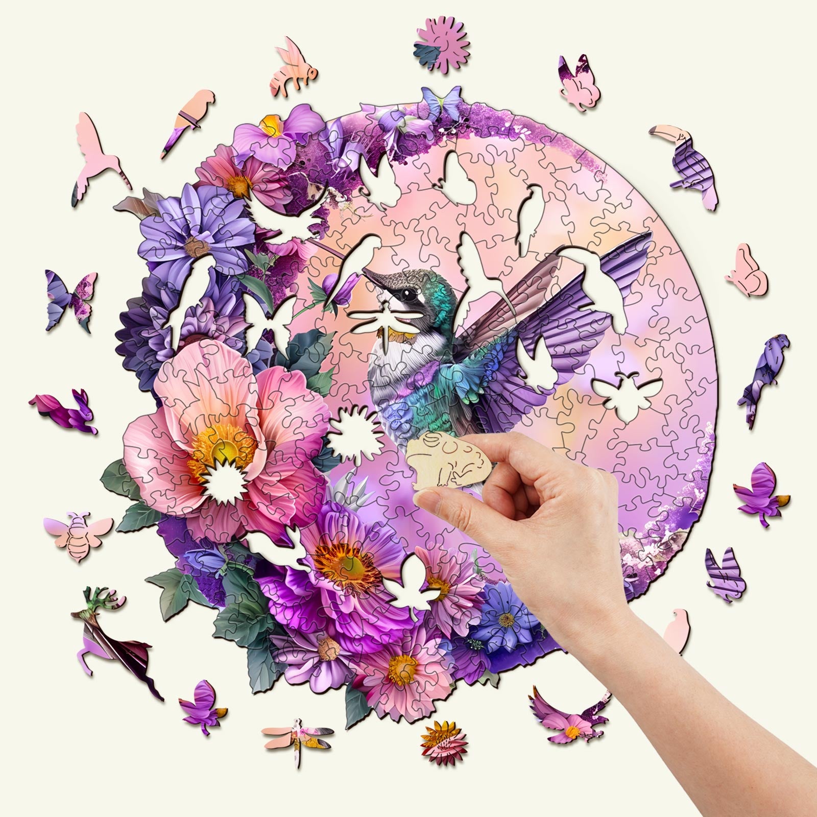 Hummingbird and Moon wooden jigsaw puzzle being assembled with colorful floral pieces.