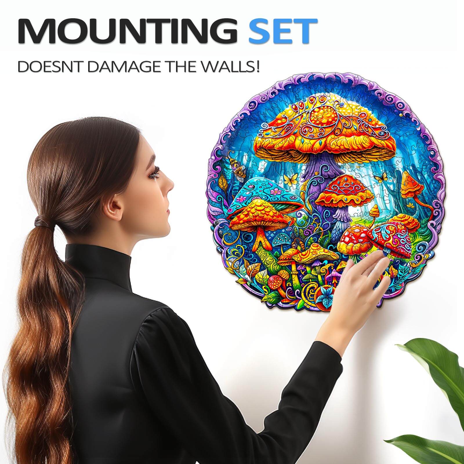 Woman mounting a vibrant magical mushrooms jigsaw puzzle on the wall, showcasing creativity with no damage.