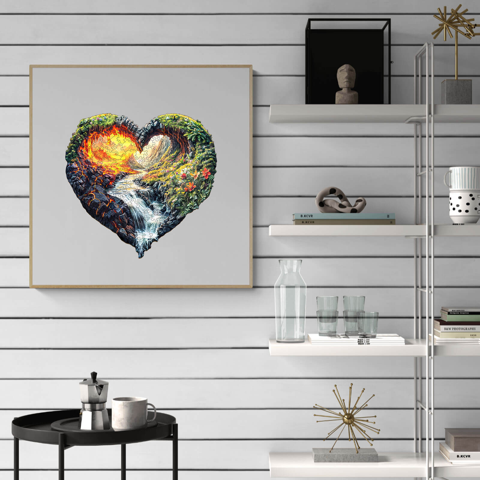 Heart-shaped artwork depicting a vibrant landscape with fire and water elements, showcased on a modern shelf.