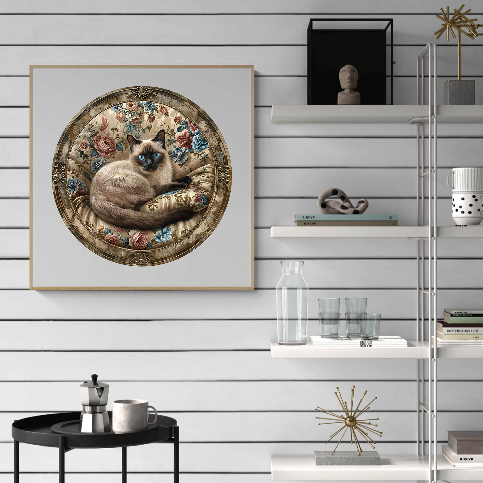 Vintage Siamese cat artwork framed with floral details, displayed on a modern shelf interior.