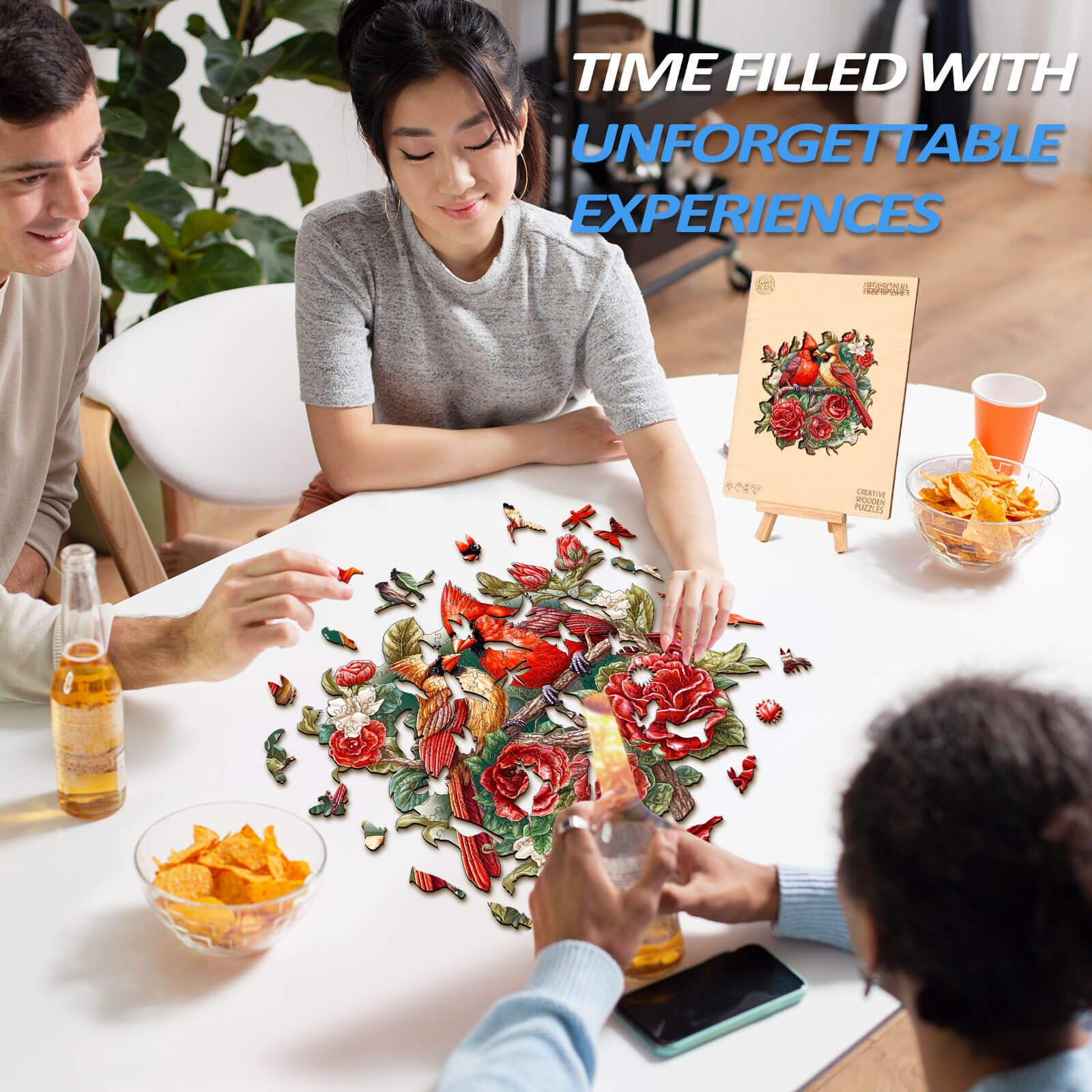 Friends enjoying a beautiful cardinal wooden jigsaw puzzle surrounded by snacks and drinks.