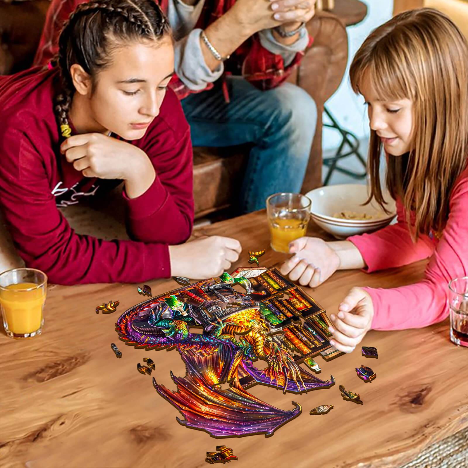 Two girls enjoying the Dragon Magic Potion wooden jigsaw puzzle on a table, surrounded by drinks and laughter.