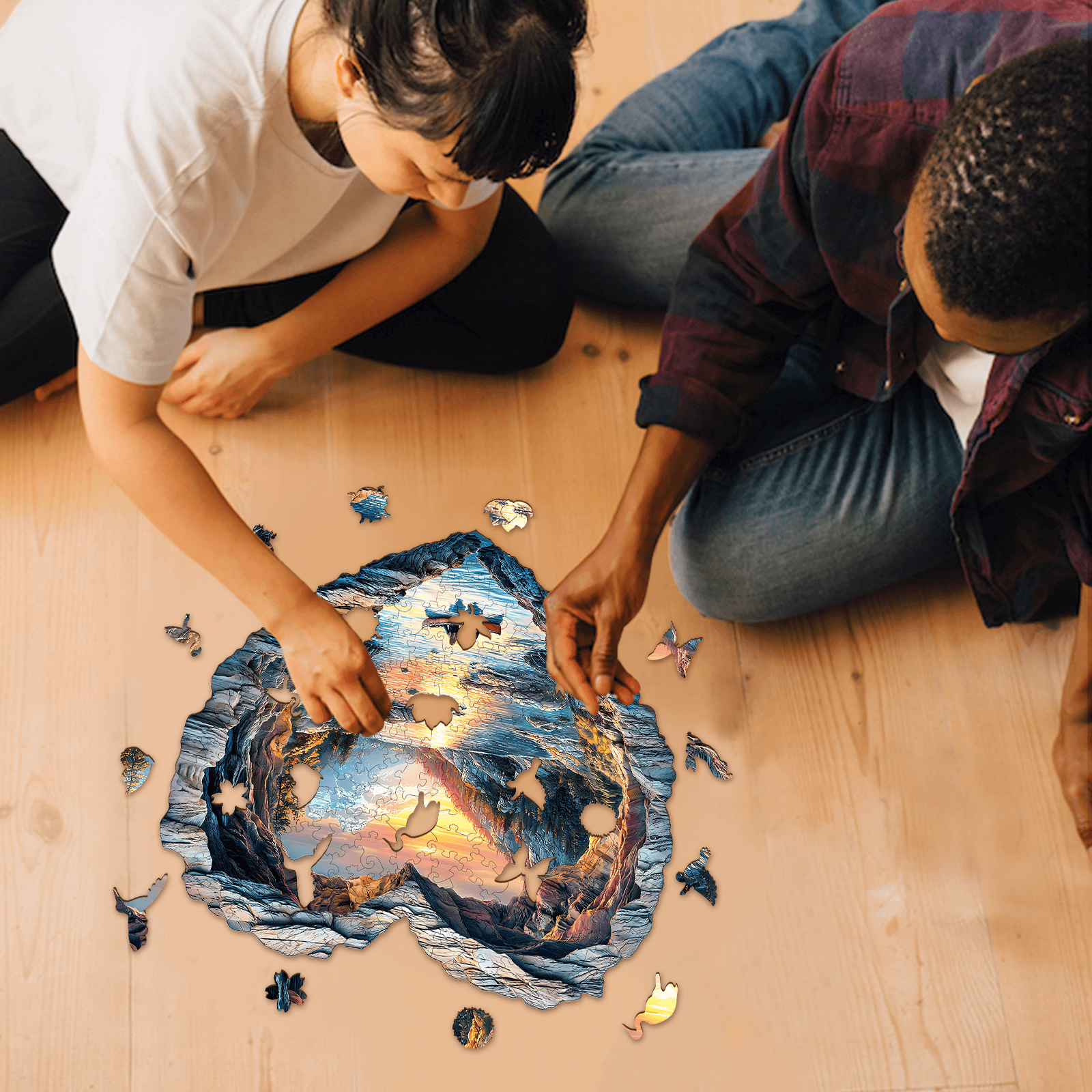 Two people assembling a 3D Lake Louise wooden jigsaw puzzle on a wooden floor, promoting focus and cognitive skills.