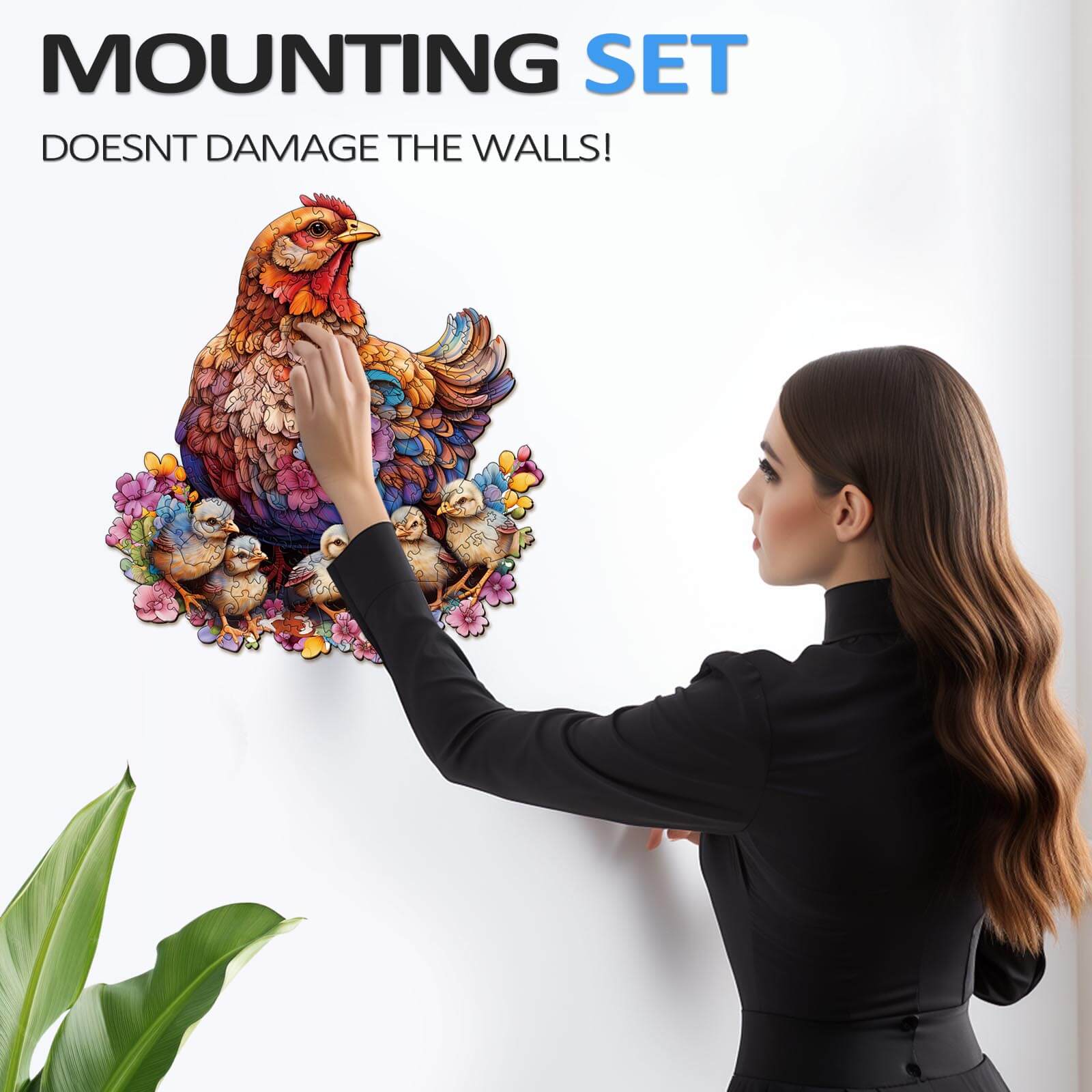 Woman using a wall mounting set to attach a colorful chicken and chicks decor without damaging the wall.