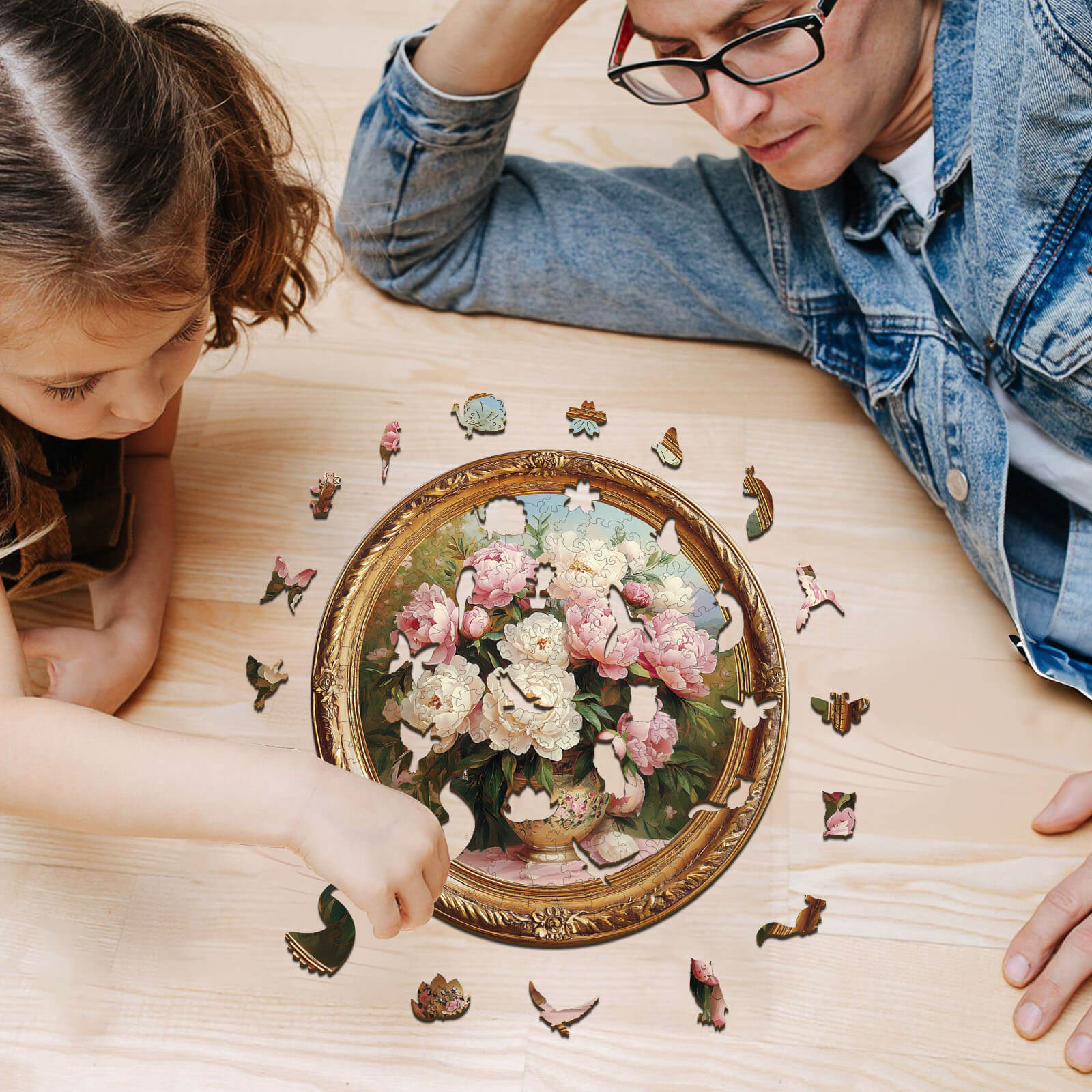 Father and daughter assembling a 3D Tranquil Spring Day wooden jigsaw puzzle on a wooden table.