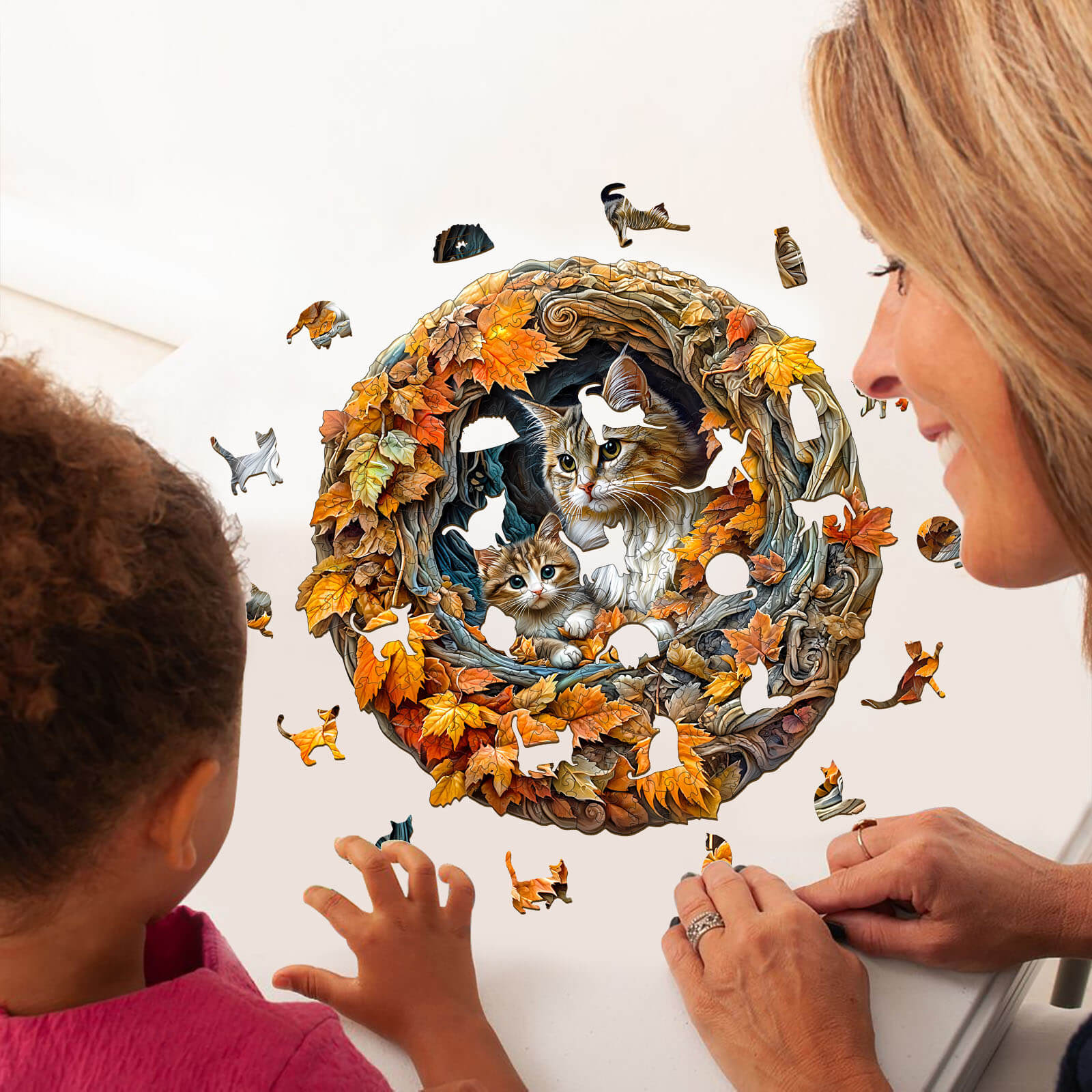 Adult and child enjoying a 3D cat mom jigsaw puzzle featuring a colorful autumn scene and playful cats.