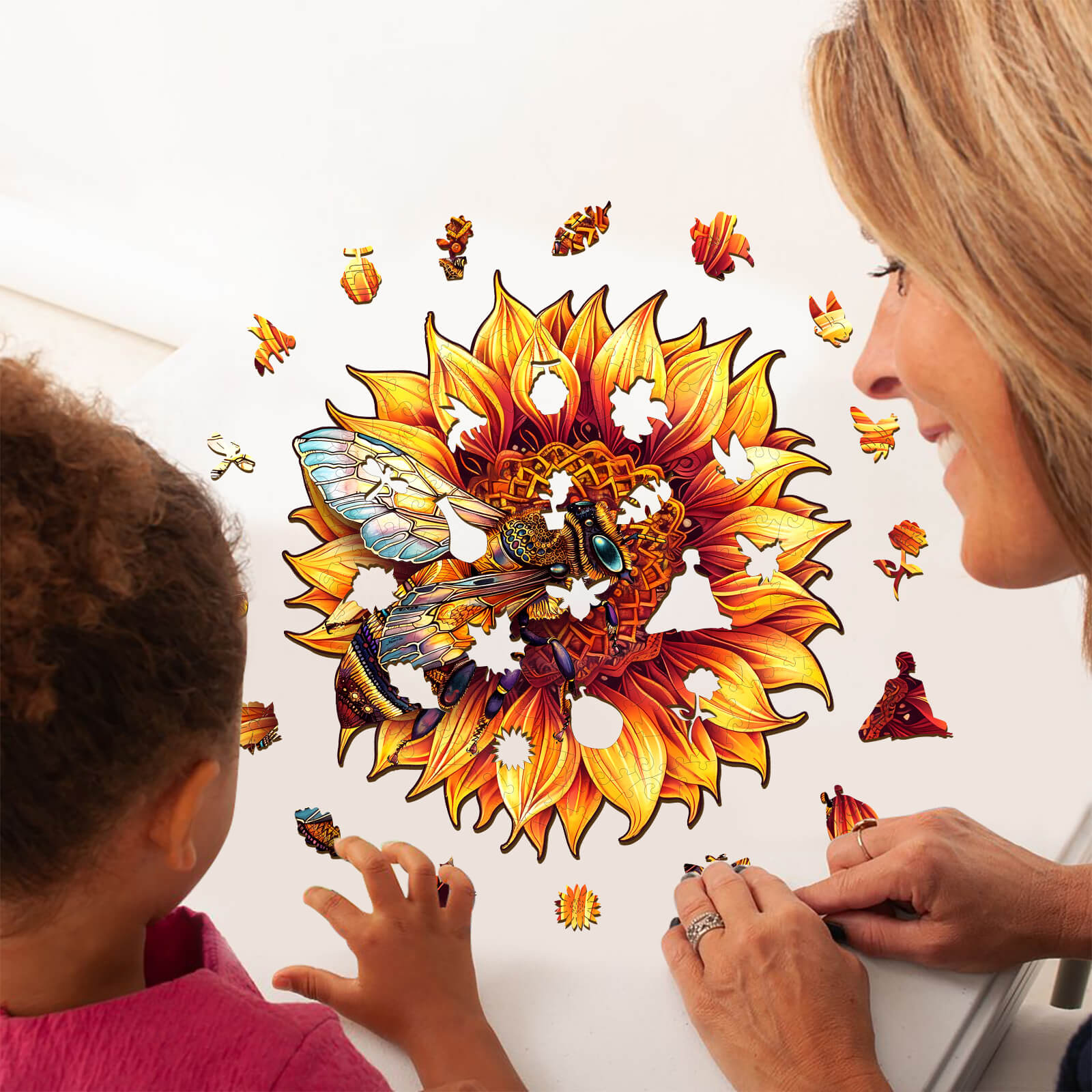 A woman and child enjoy assembling a colorful bee and sunflower wooden jigsaw puzzle on a table, promoting focus and cognitive skills.