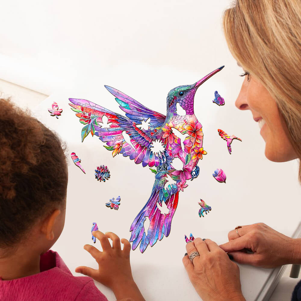 Colorful Hummingbird-3 Wooden Jigsaw Puzzle being solved by a child and adult, promoting focus and enhanced cognitive skills.